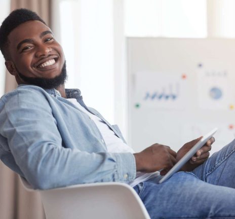 smiling-african-american-guy-sitting-at-work-with-2021-08-26-16-34-01-utc.jpg